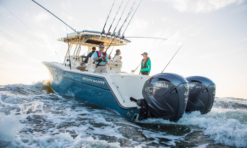 Four people are taking a ride to go fishing on a Grady-White® boat with two Yamaha® outboards.