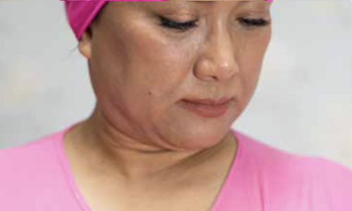 woman wearing pink headwear, pink blouse and pink pin