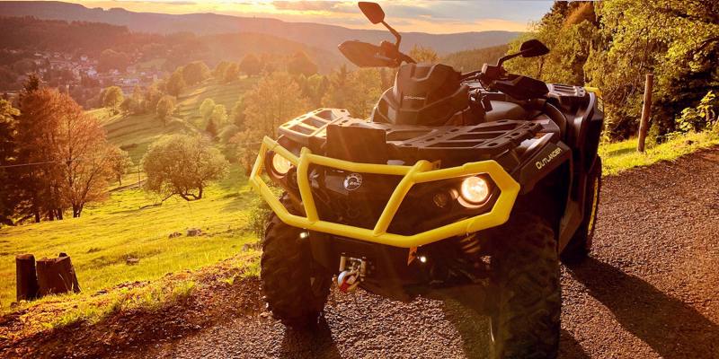 ATV with a yellow grill at sunset 